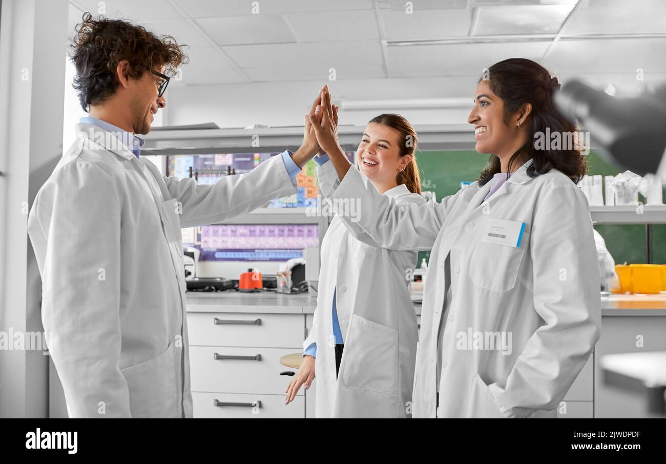 happy international scientists in laboratory Stock Photo