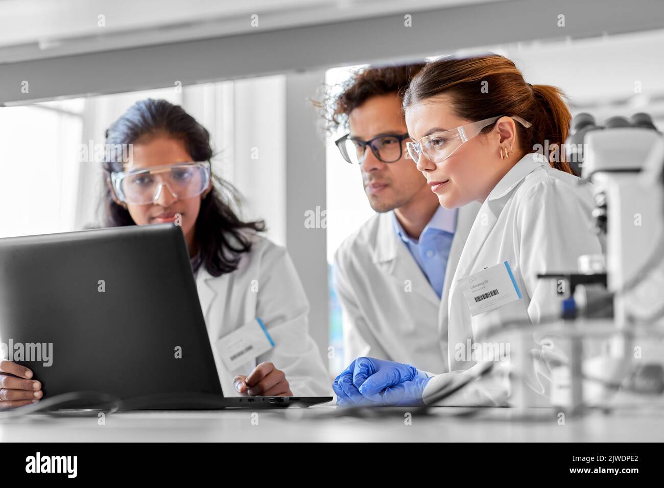 scientists with laptop working in laboratory Stock Photo