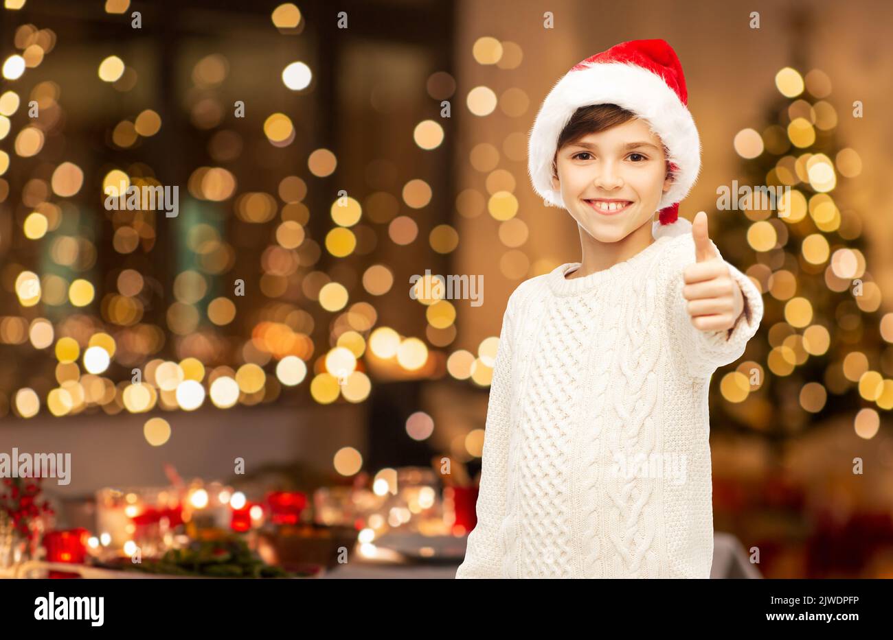 happy boy showing thumbs up on christmas Stock Photo - Alamy