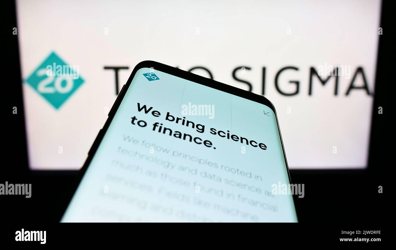 Smartphone with webpage of American hedge fund company Two Sigma Investments LP on screen in front of logo. Focus on top-left of phone display. Stock Photo