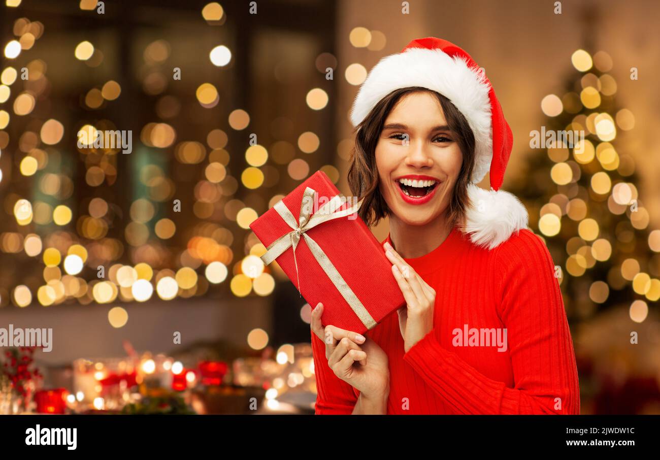 happy woman in santa hat with red christmas gift Stock Photo