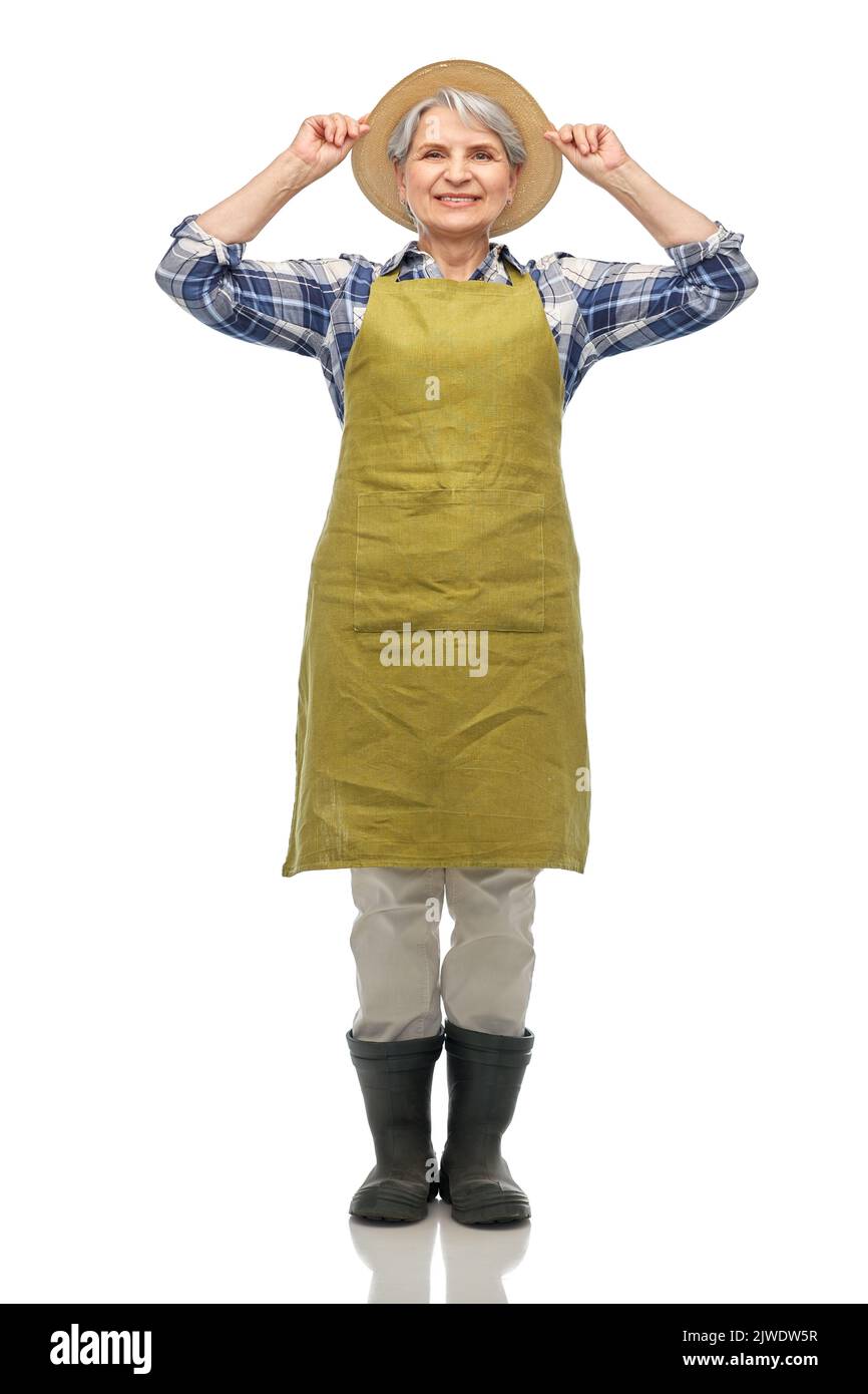 smiling senior woman in garden apron and straw hat Stock Photo