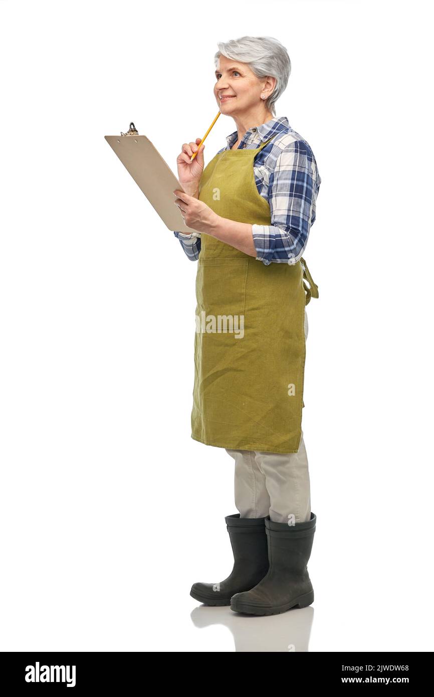 senior woman in garden apron with clipboard Stock Photo