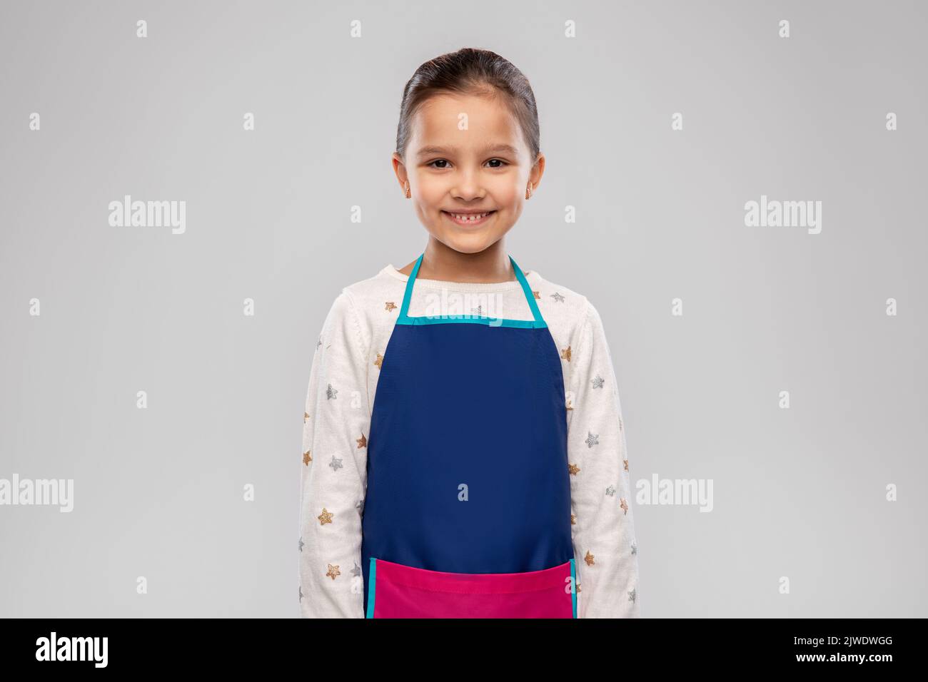smiling little girl in apron Stock Photo