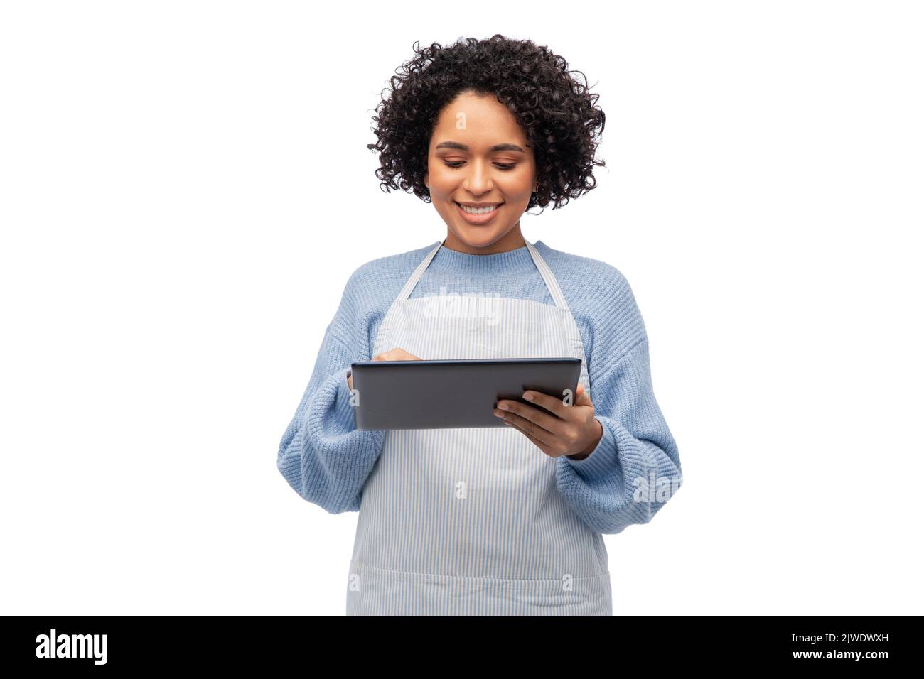 smiling woman in apron with tablet pc computer Stock Photo