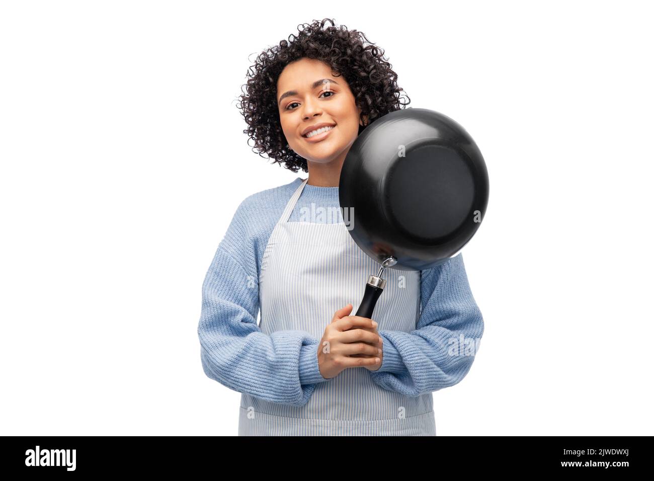 smiling woman in apron with frying pan Stock Photo