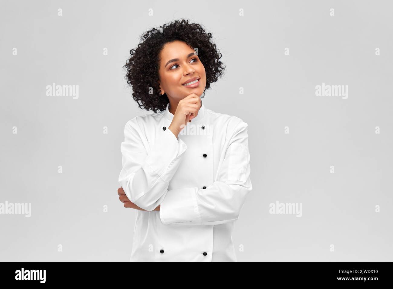 smiling female chef in white jacket Stock Photo
