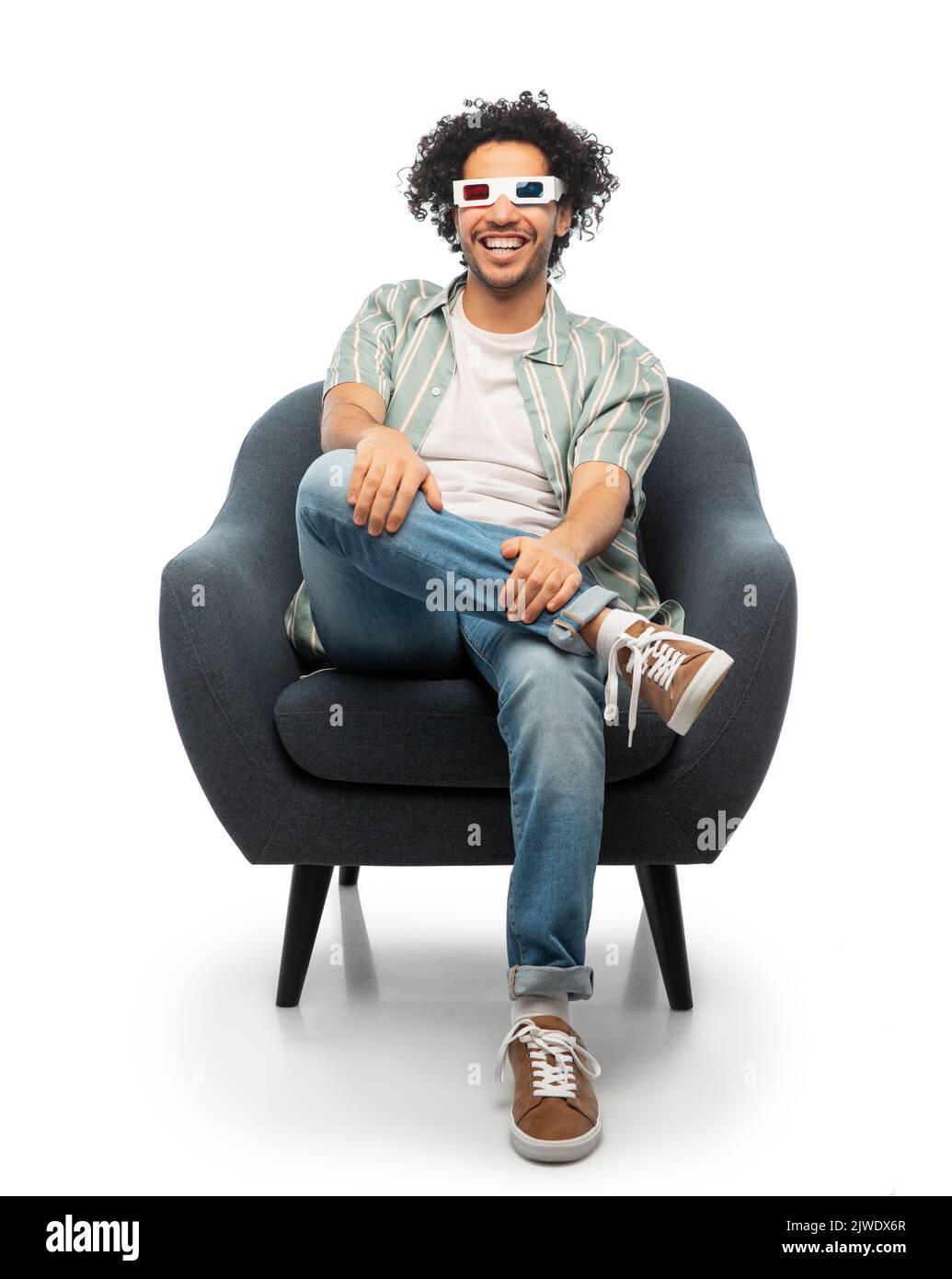 man in 3d glasses watching movie sitting in chair Stock Photo