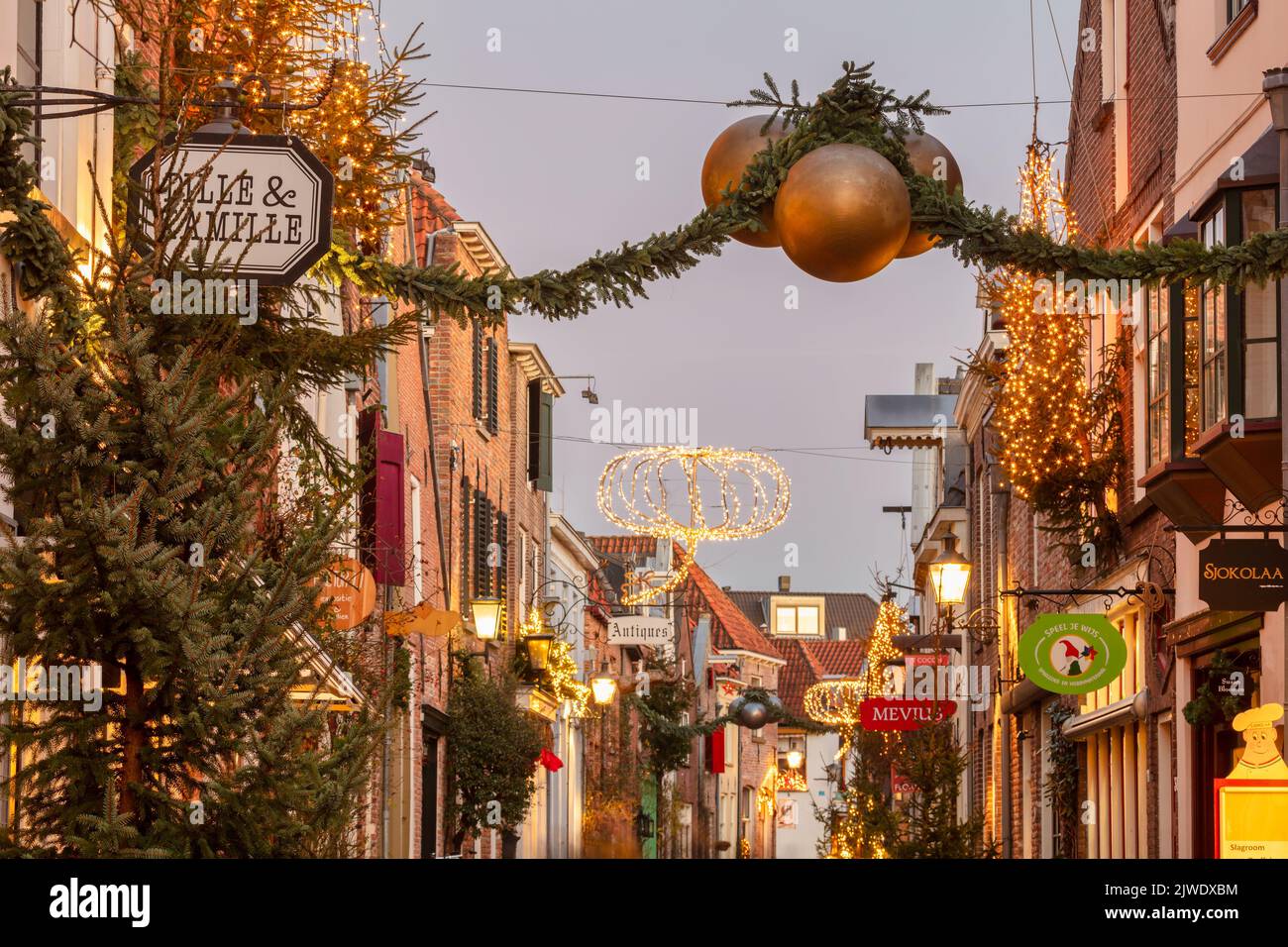 The famous old Walstraat shopping street with christmas decoration in the Dutch city center of  in Deventer Stock Photo