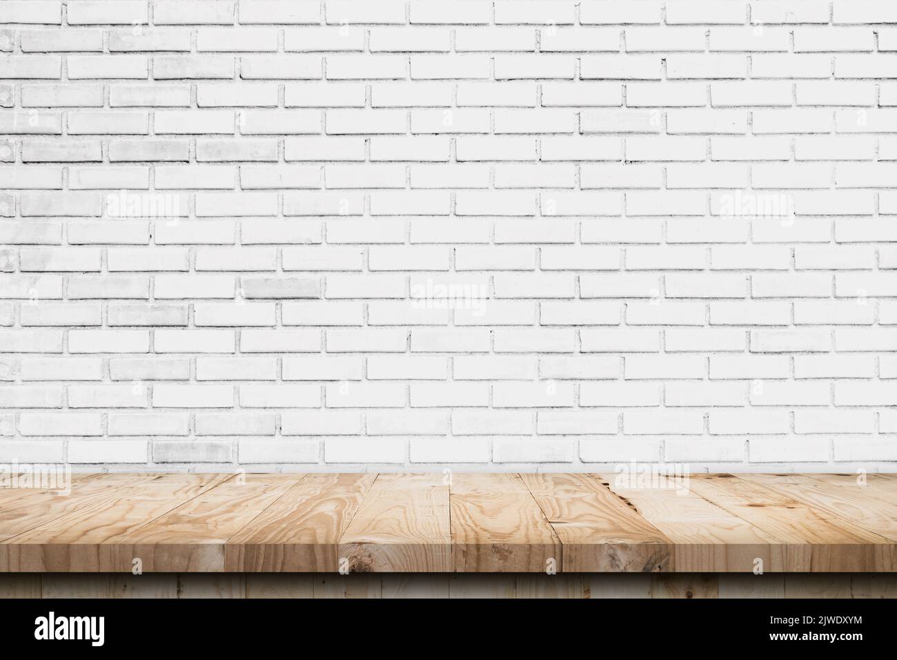 Empty wooden table top and white brick wall and rough crack background texture Stock Photo