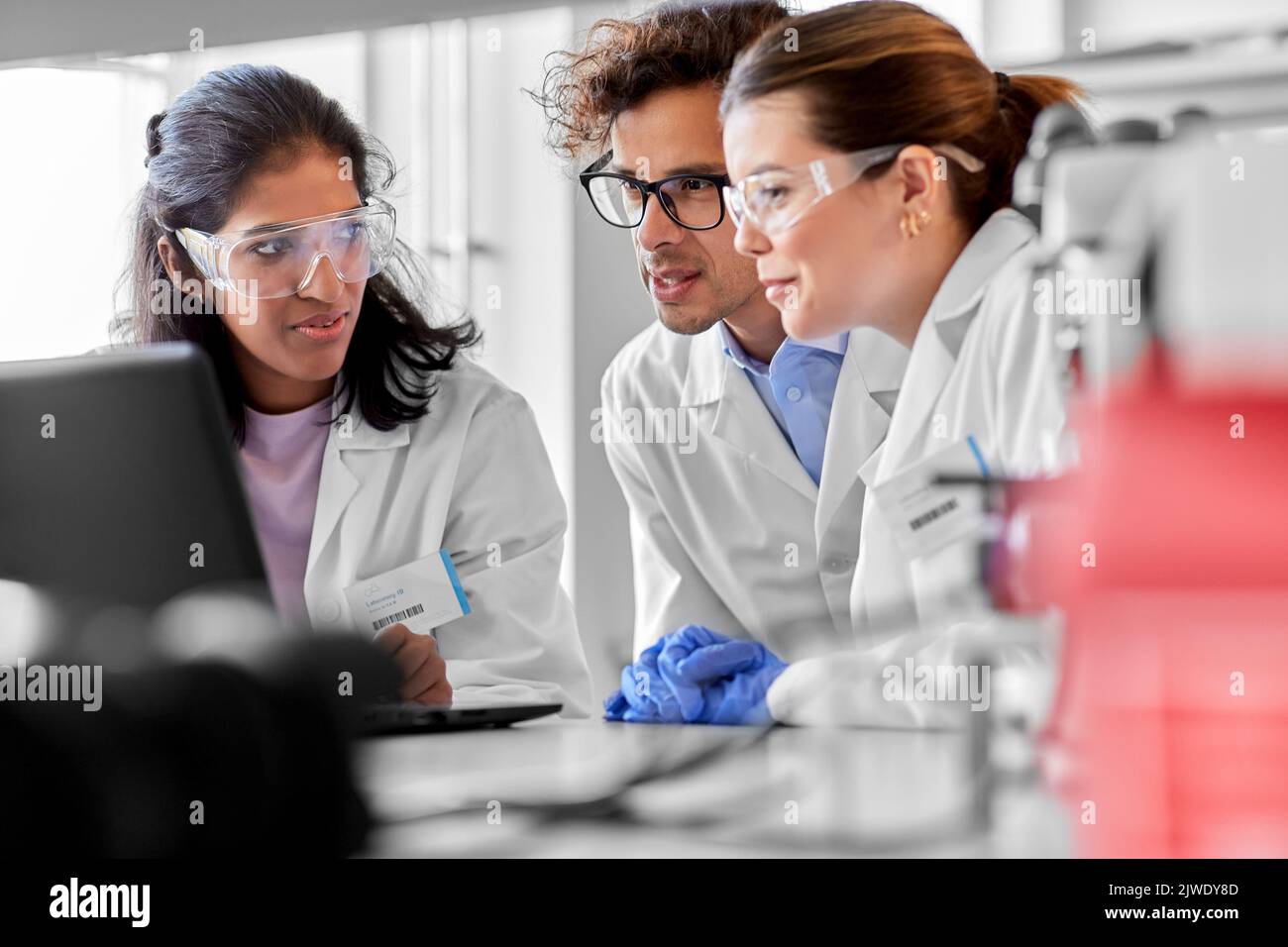 scientists with laptop working in laboratory Stock Photo
