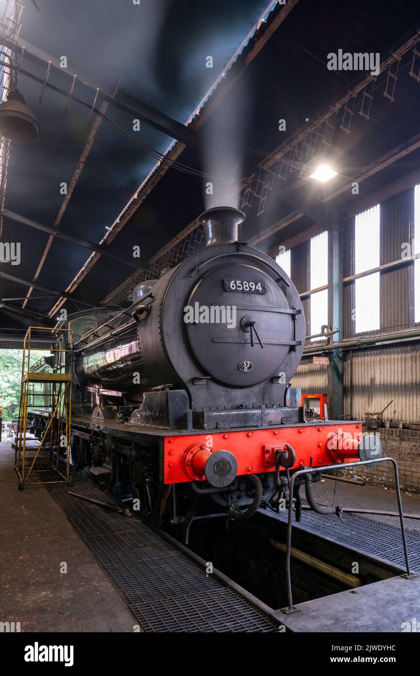 A steam engine 'steaming down' in the engine sheds at Grosmont on the North Yorkshire Moors Railway Stock Photo