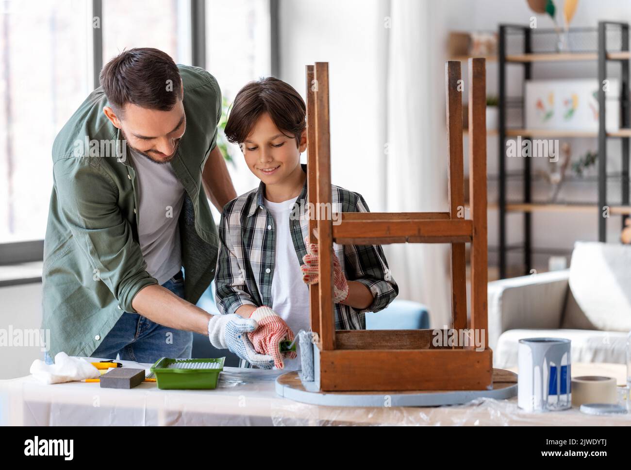 father and son painting old table in grey color Stock Photo Alamy