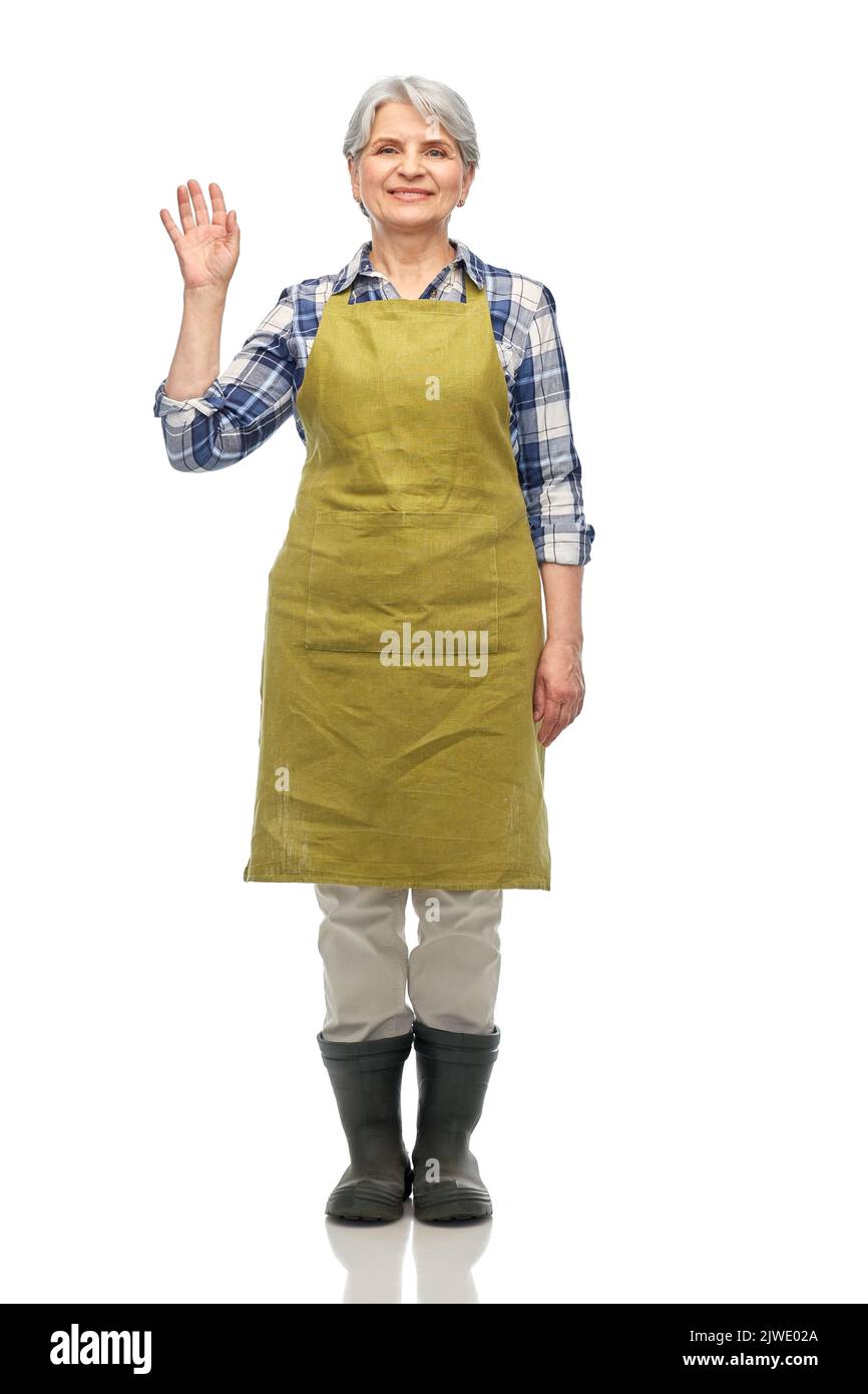 portrait of smiling senior woman in garden apron Stock Photo - Alamy