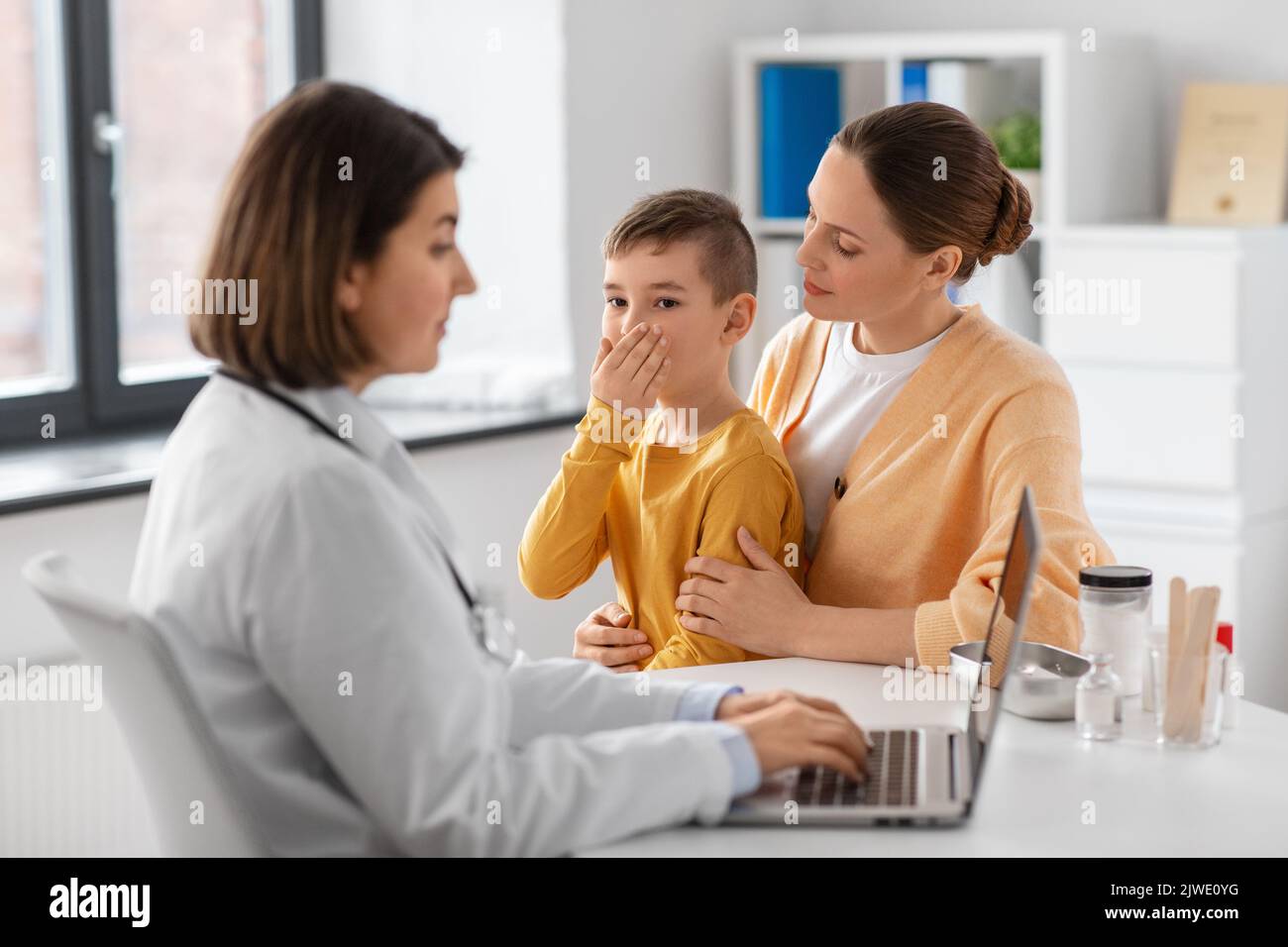 mother, son and doctor with laptop at clinic Stock Photo - Alamy