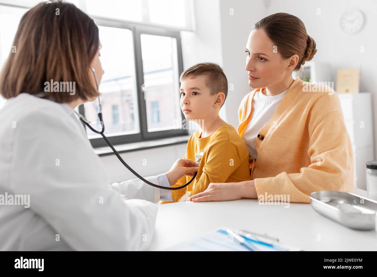 mother, son and doctor with stethoscope at clinic Stock Photo - Alamy