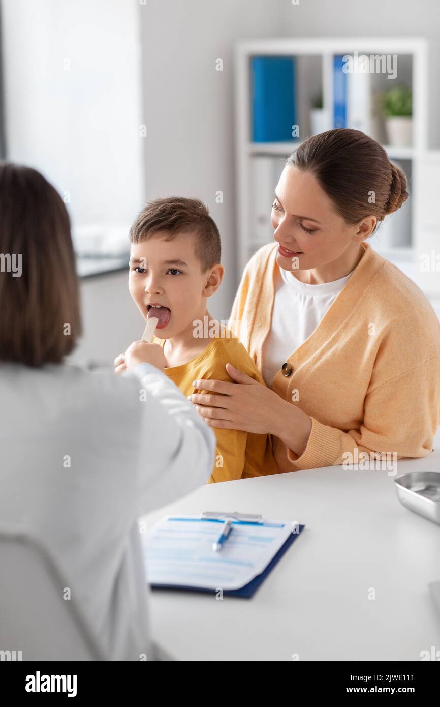 smiling mother, son and doctor talking at clinic Stock Photo - Alamy