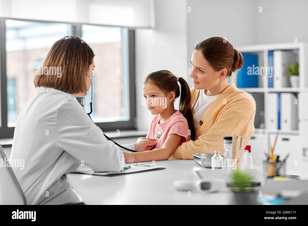 mother, girl and doctor with stethoscope at clinic Stock Photo - Alamy