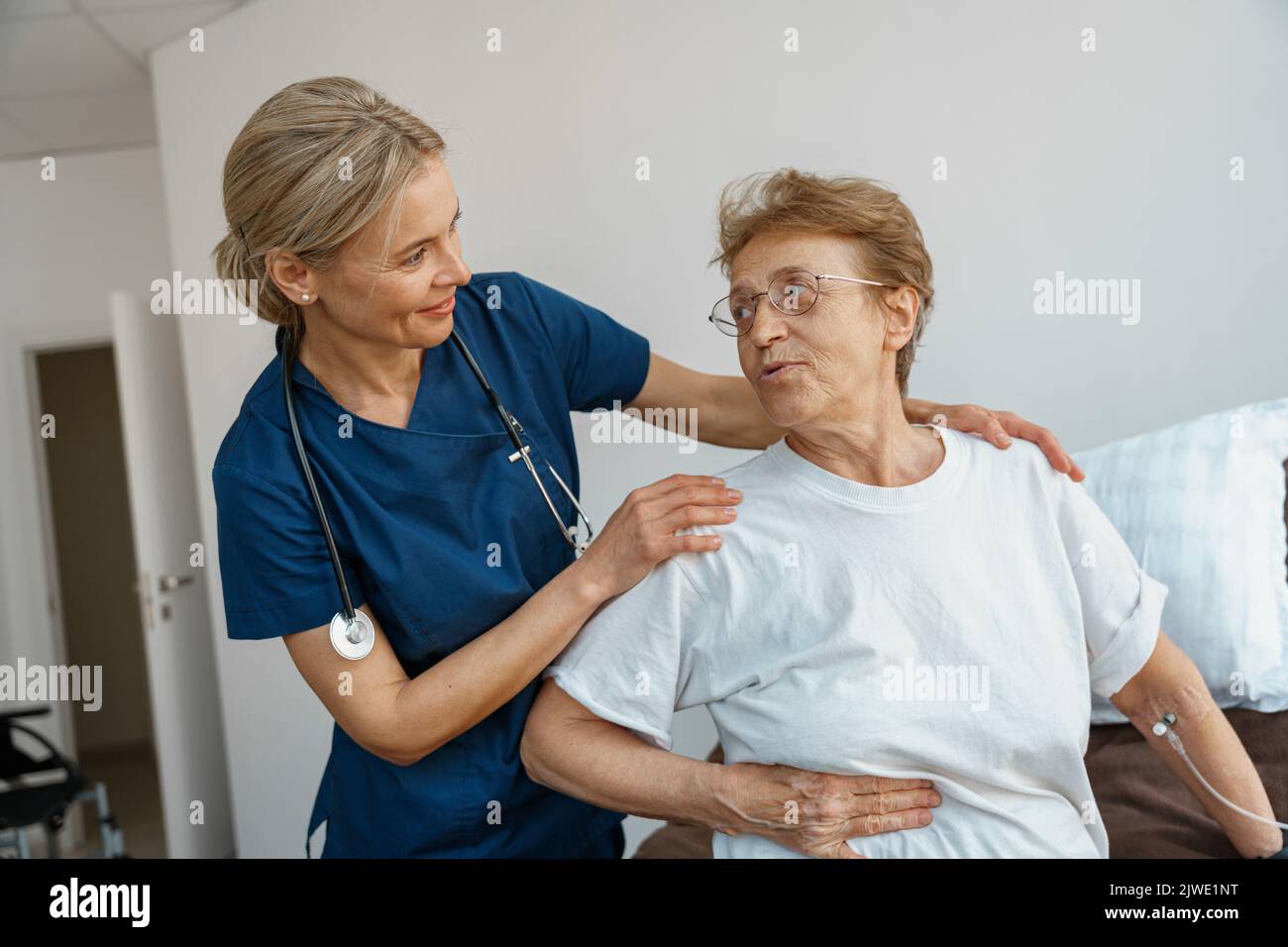 Doctor supporting a sick patient before medical procedures in a ...