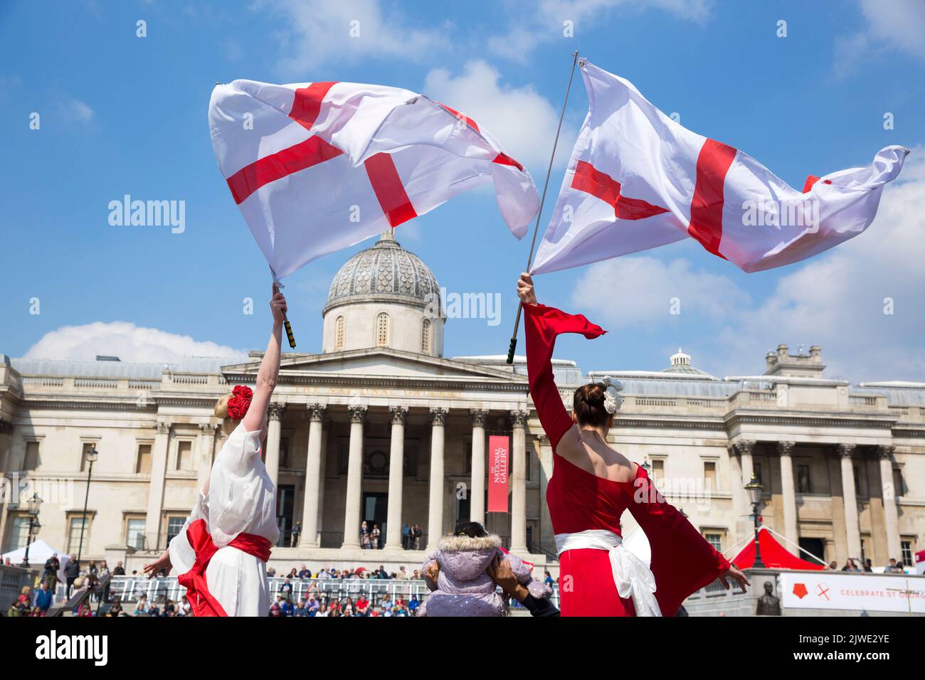 People watch acrobatic performances as they gather for St George’s Day celebrations in Trafalgar Square, central London. Stock Photo