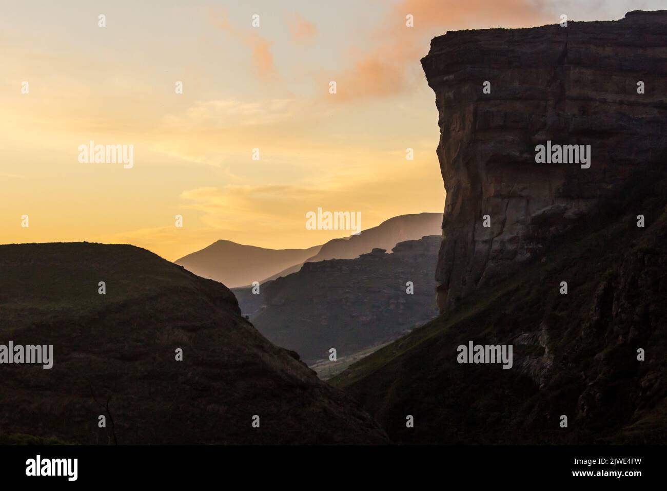 Enchanted Drakensberg sunset, with the silhouette of the Sentinel Buttress of the Golden Gate Highlands National Park, South Africa Stock Photo