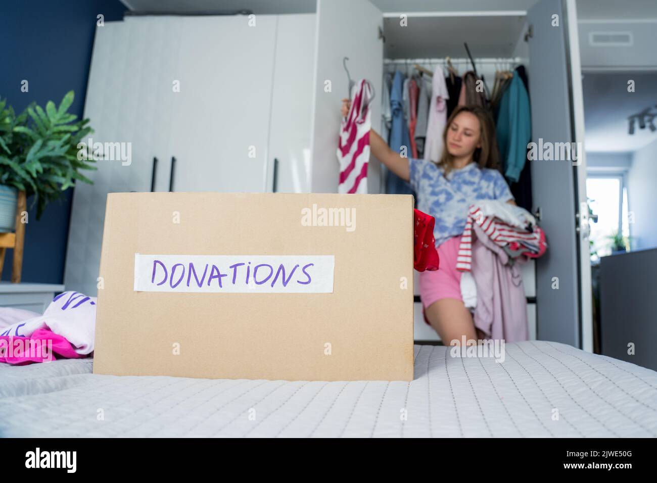 A cardboard box of selected clothes for donating to a Charity shop
