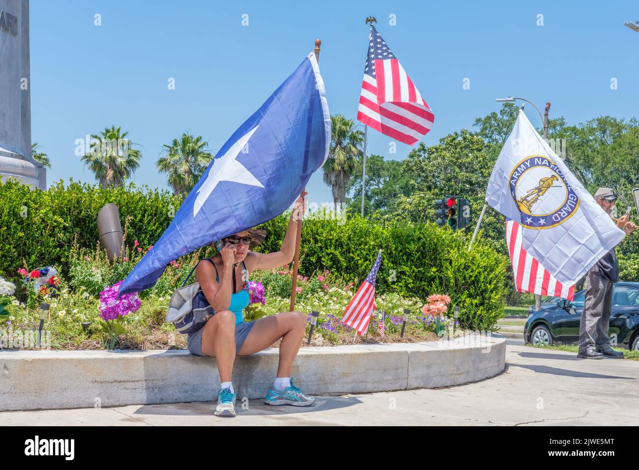 NEW ORLEANS, LA, USA-MAY 7, 2017: Woman Demonstrator with Texas Flag Protesting the Removal of Confederate Statues at Beauregard Statue near City Park Stock Photo