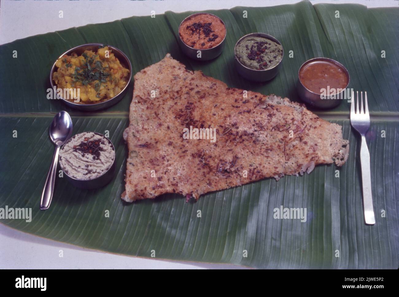 South Indian Snacks, Rava Dosa on Banana Leaf Stock Photo - Alamy