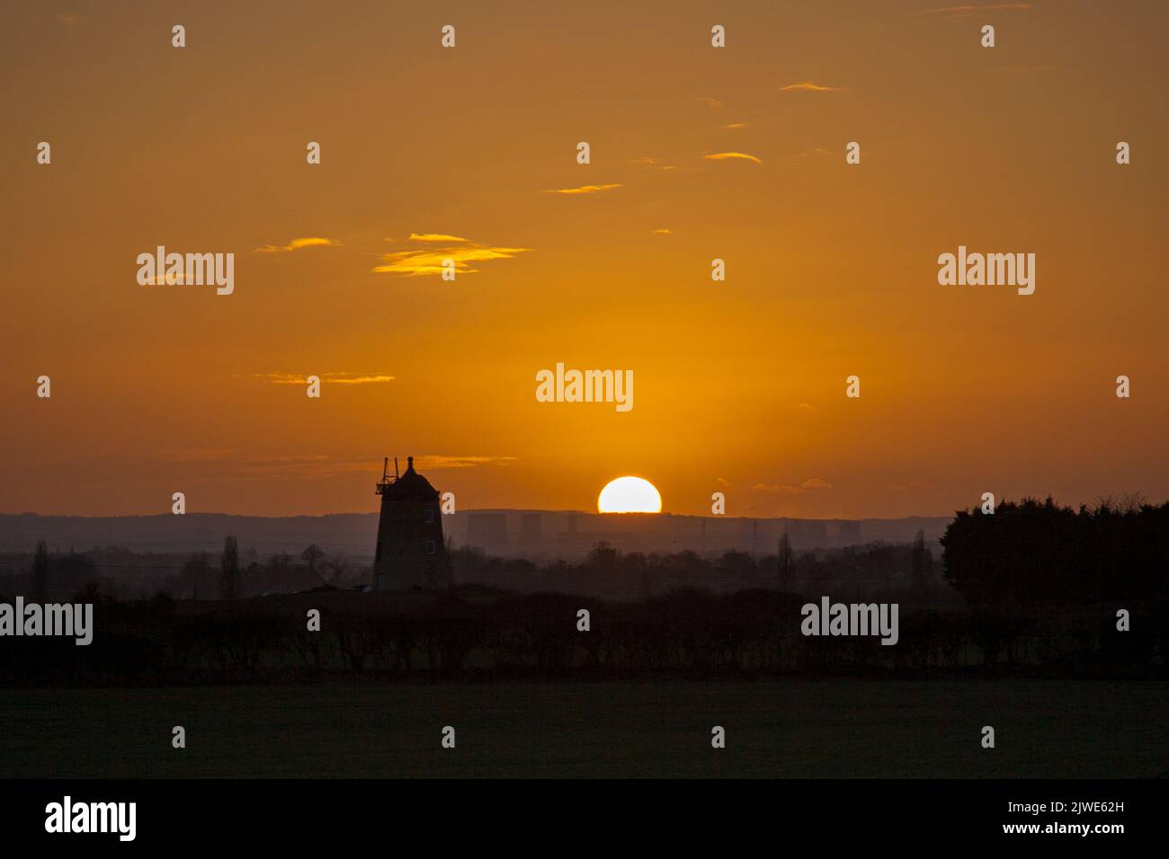 The sunset behind the old windmill at Little Milton, Oxfordshire Stock