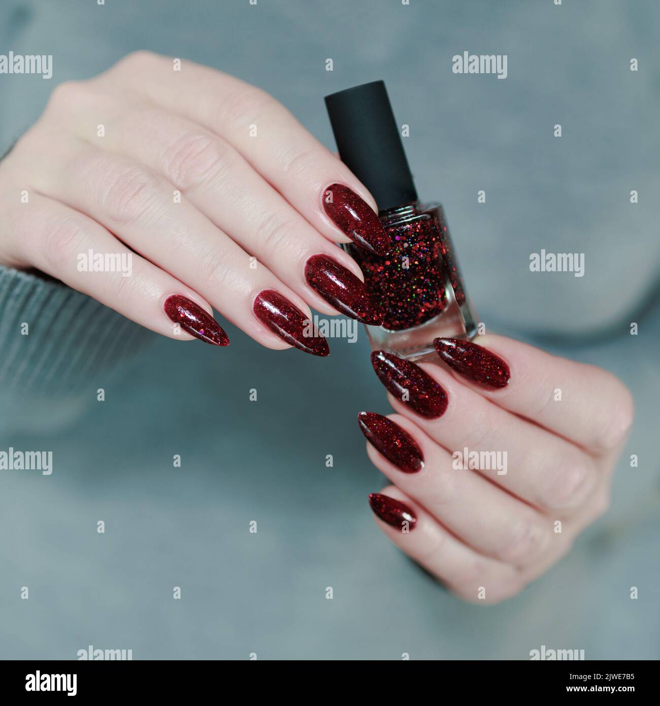 Female Hand with a Beautiful Glossy Manicure - Burgundy, Dark Red, Cherry  Color Nails on Background of Silver Christmas Tinsel Stock Photo - Image of  burgundy, care: 197056540