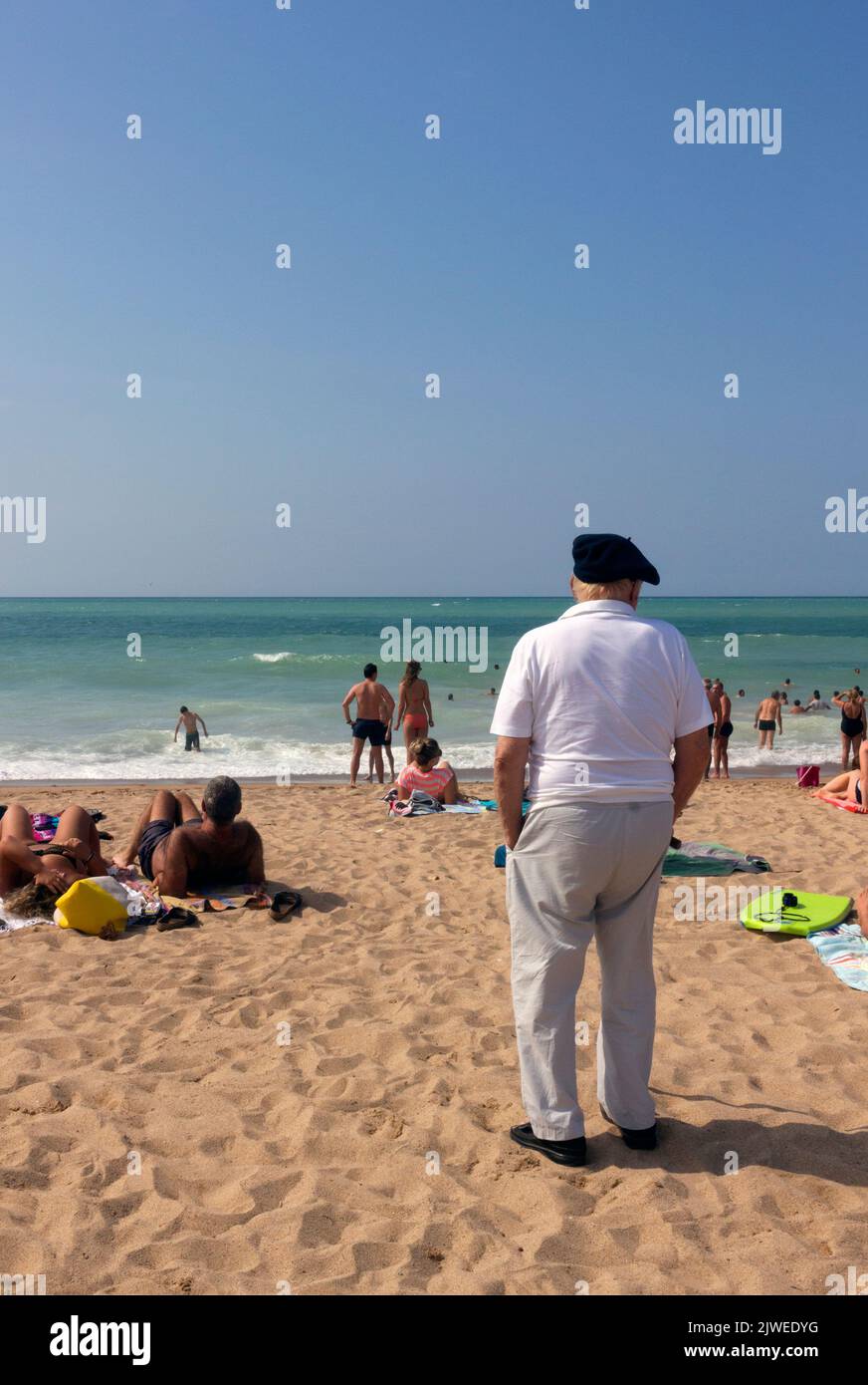 Uhabia Beach. Holiday activities. Basque with his traditional beret contrasting with the other users. Bidart, Pyrenees-Atlantiques, France Stock Photo