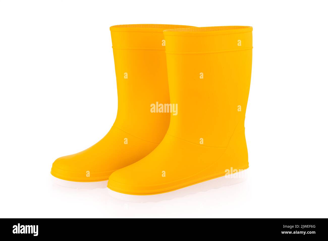 Yellow rubber boots isolated on white background. Kids shoes. Stock Photo