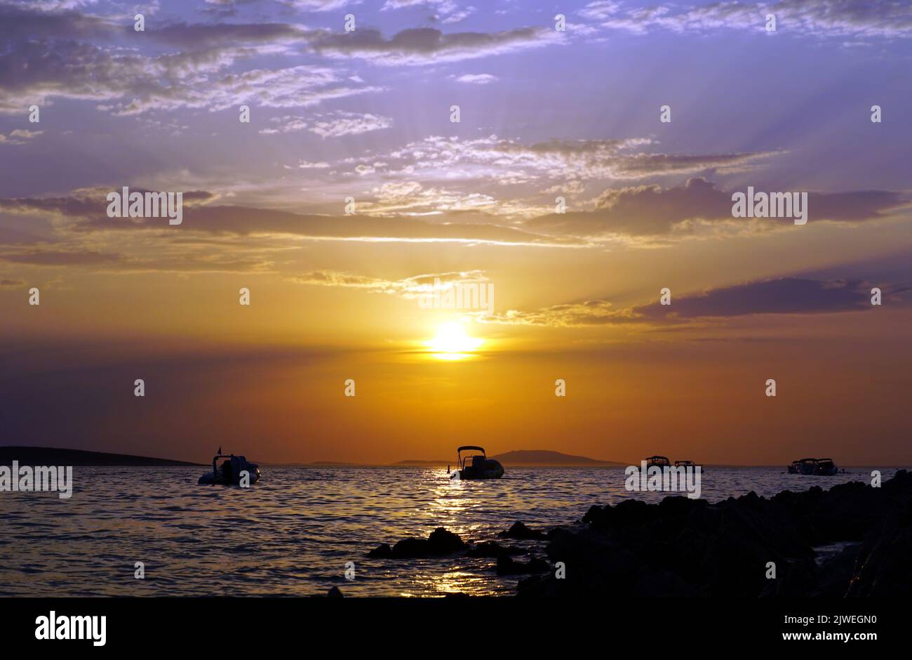 Purplish sky during blue hour at evening in stunning seascape at summertime Stock Photo
