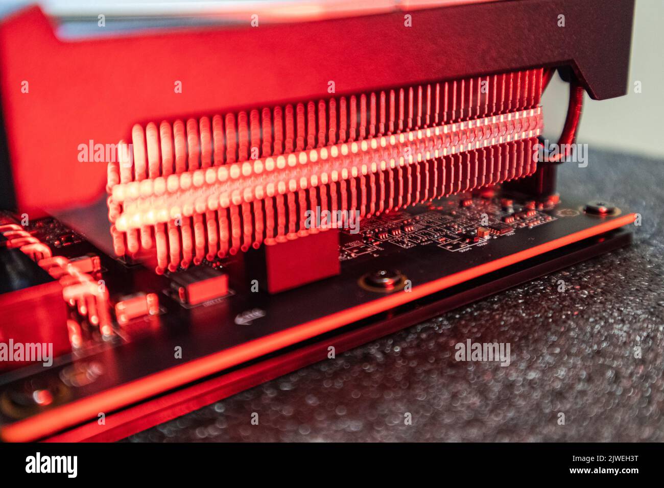 Gpu graphics or video card cooling system close-up in red light, PC hardware electronics details, components for gamer or crypto mining Stock Photo