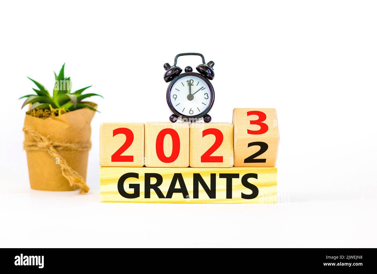Planning 2023 grants new year symbol. Turned wooden cube and changes