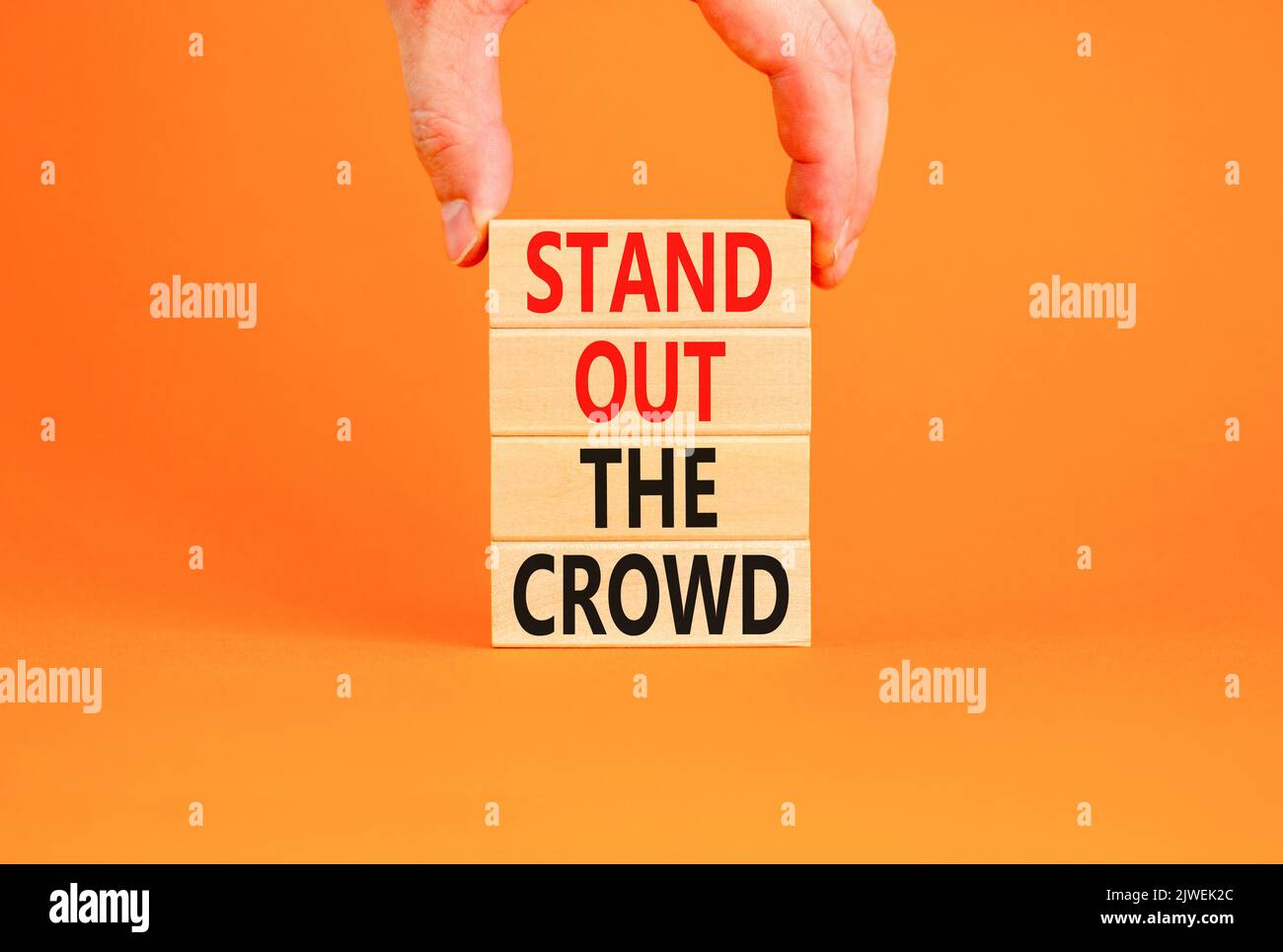 Stand out the crowd symbol. Concept words Stand out the crowd on wooden