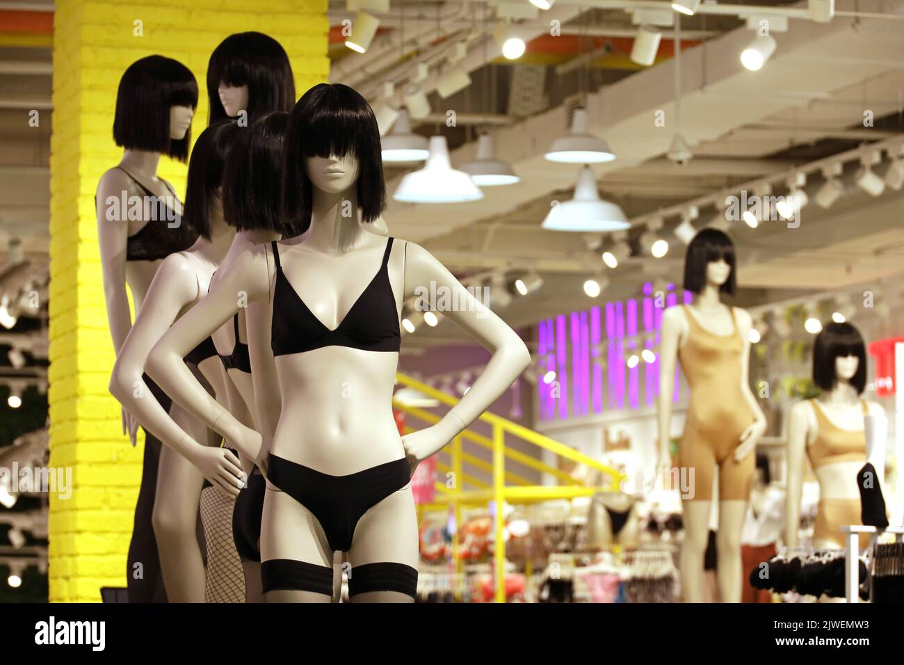 Female mannequins in black underwear and wigs. Lingerie store, bra, panties and stockings in a shop Stock Photo
