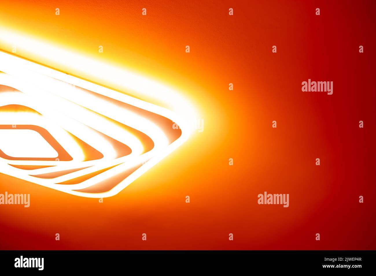 Bright LED lamp glow on the red ceiling. Stock Photo