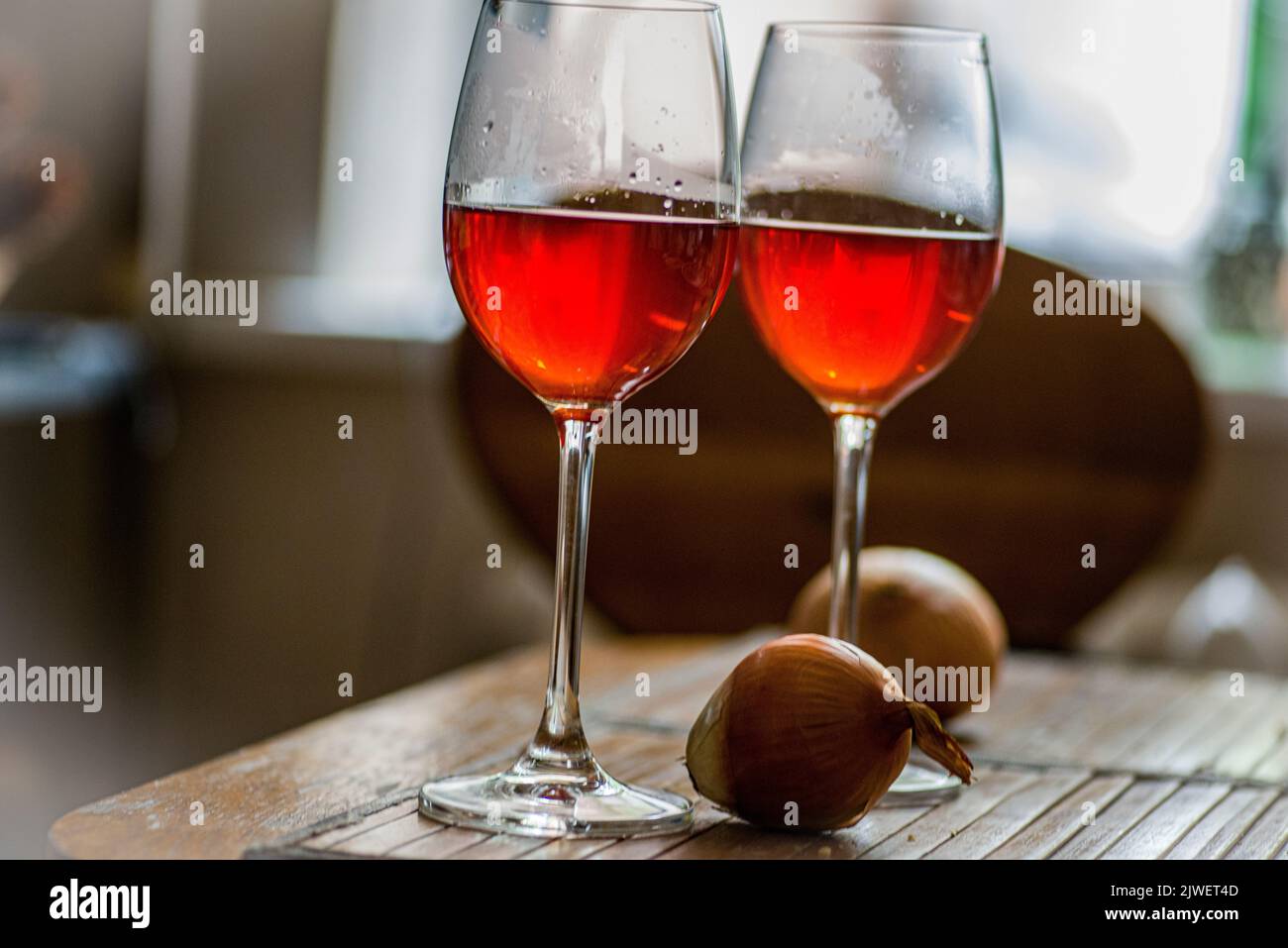 Onions and two glasses of a healthy drink, made from the onion skin
