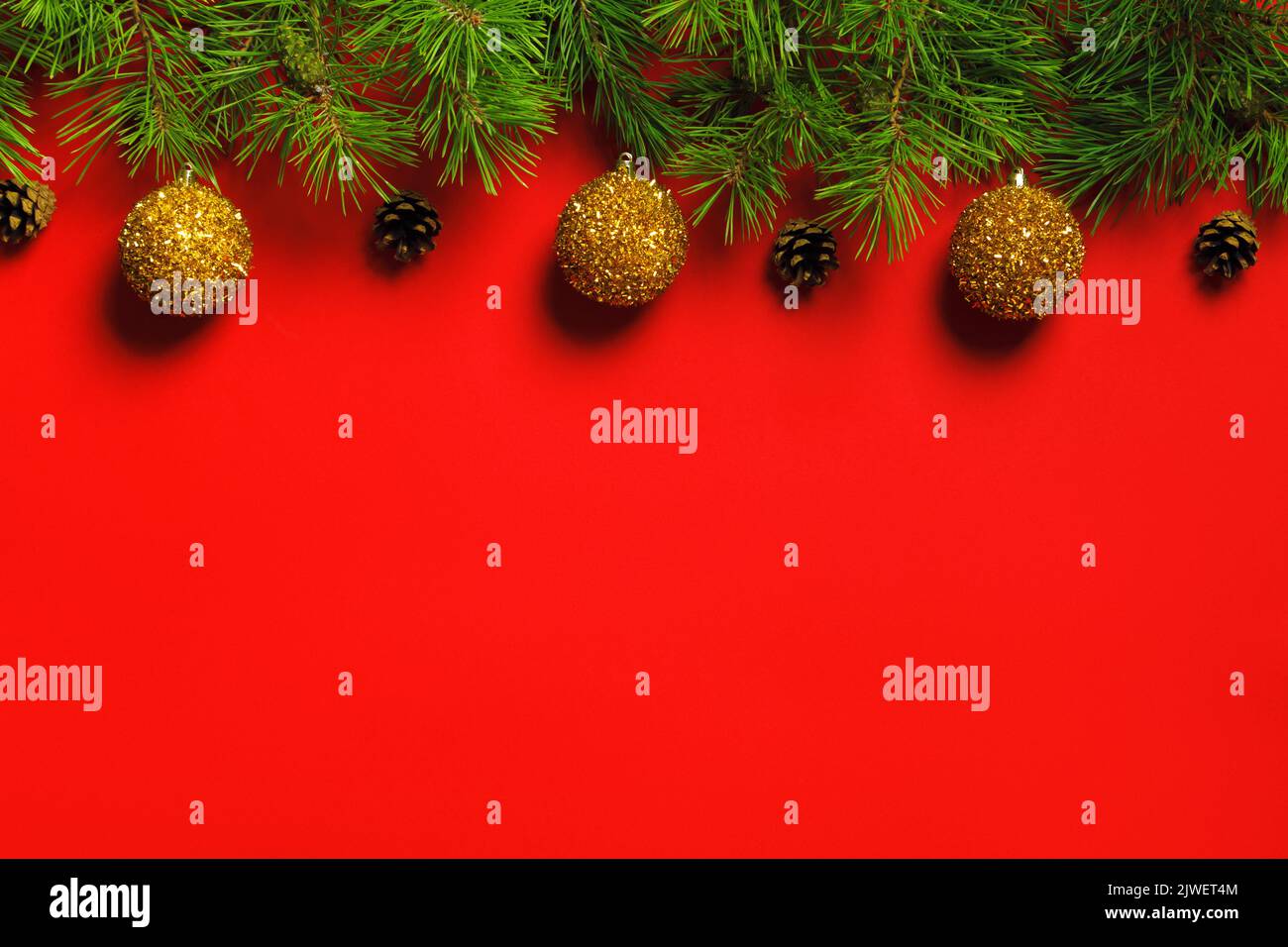 Christmas New Year banner from fir branches with cones, balls on a red ...