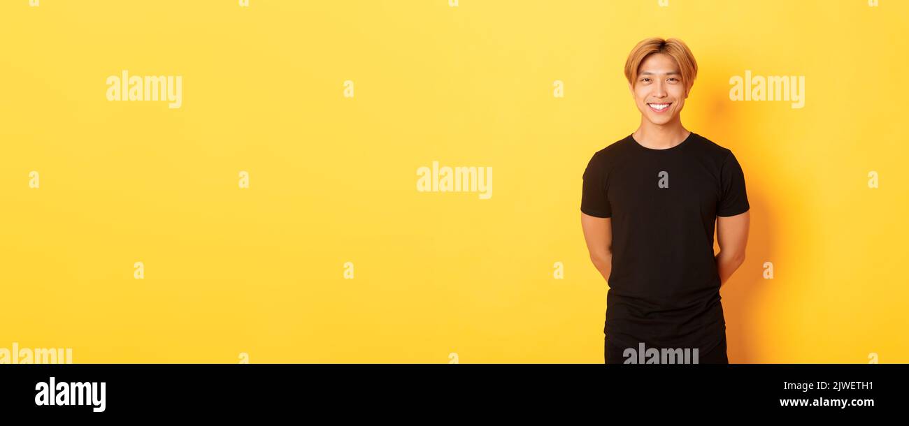 Portrait of friendly handsome asian guy with blond hair, smiling ...