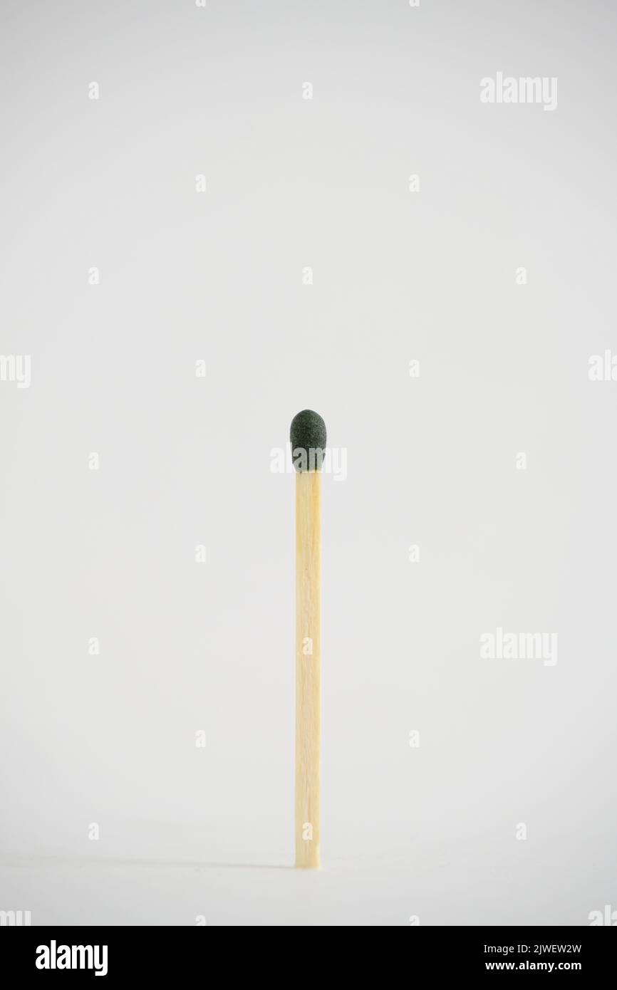 A match with green head on a white background Stock Photo