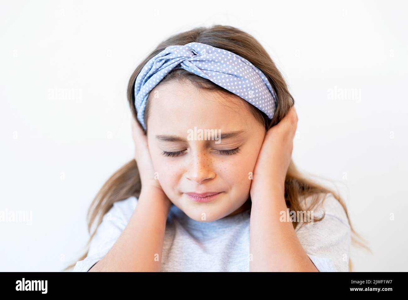 child headache stress anxiety girl clutching head Stock Photo