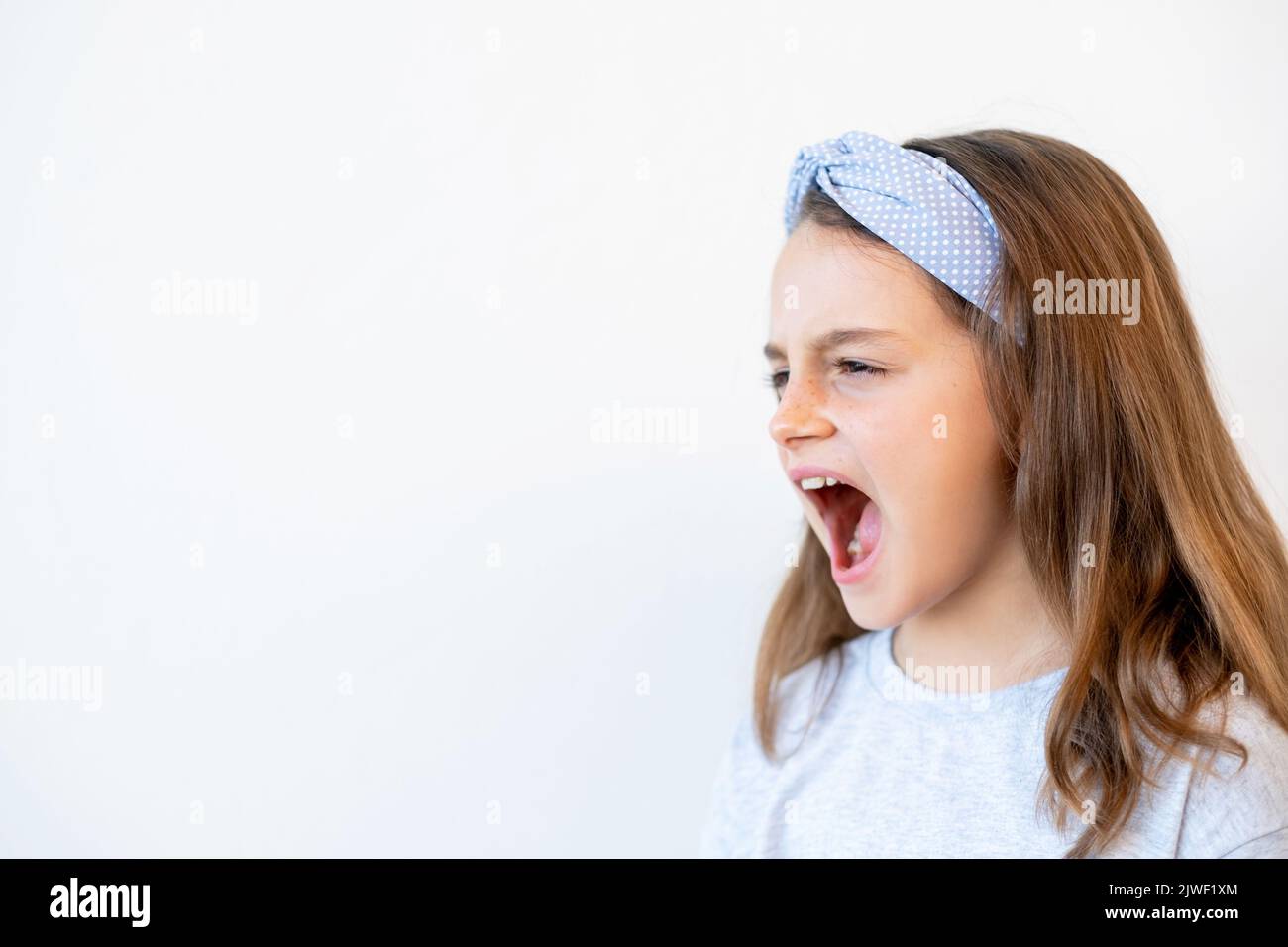 naughty kid portrait temper tantrum girl yelling Stock Photo