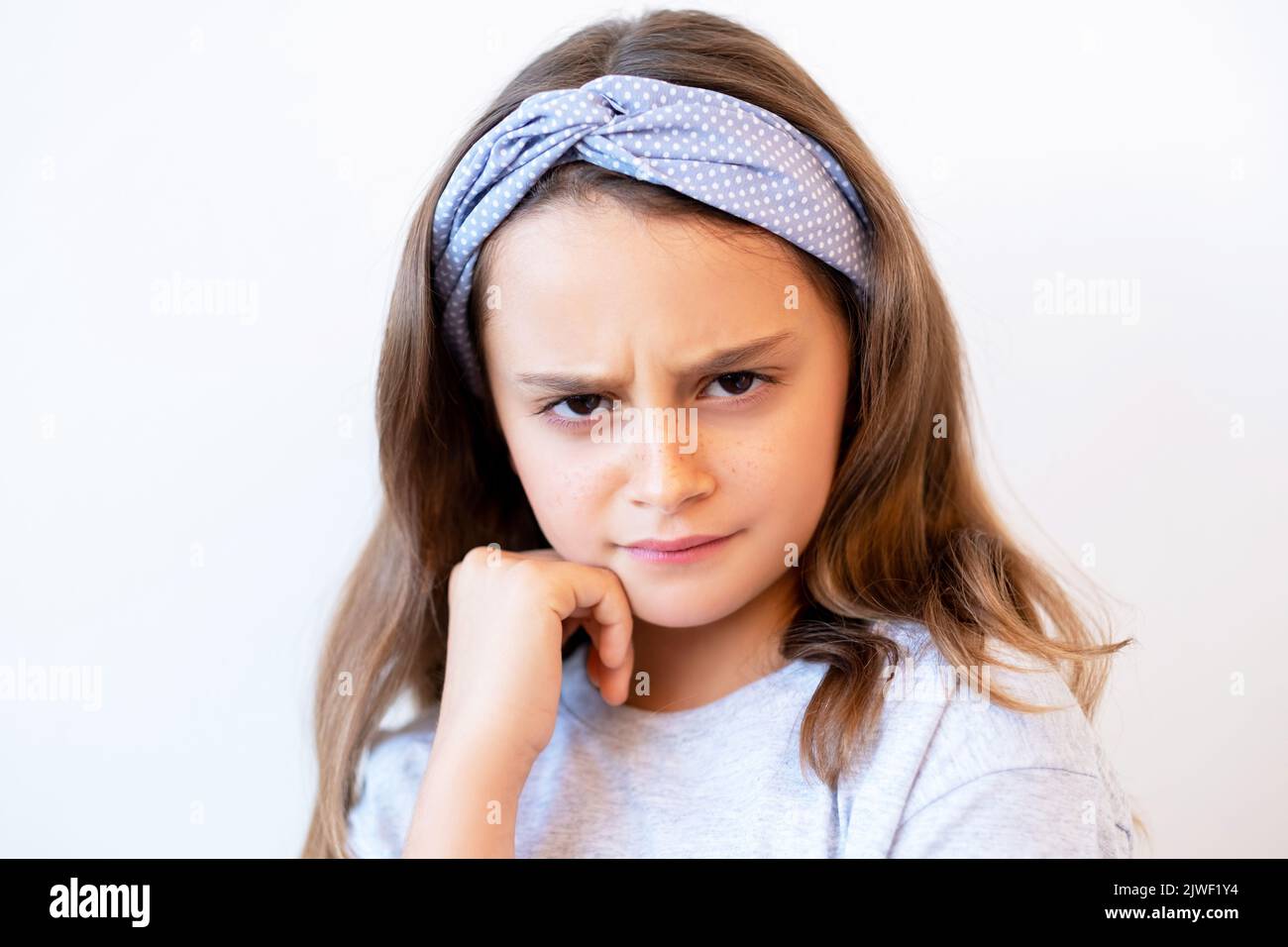 offended kid portrait unhappy stubborn girl face Stock Photo