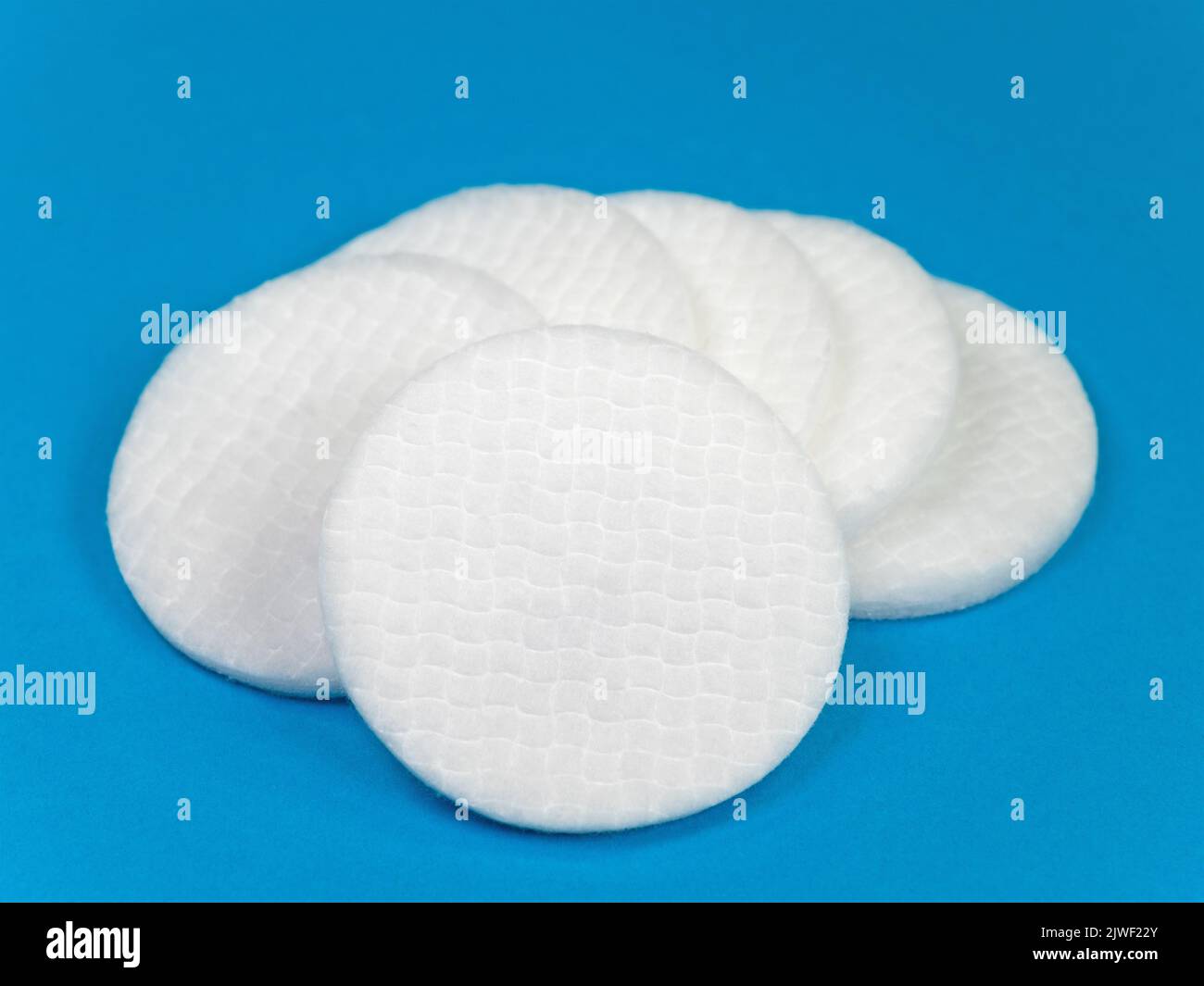 Cotton pads isolated against blue background Stock Photo