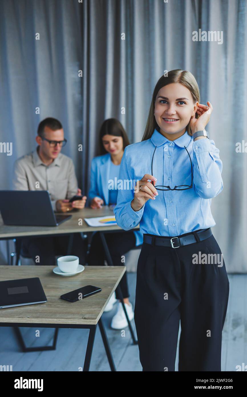 Young business lady. Manager woman in classic glasses smiling during ...