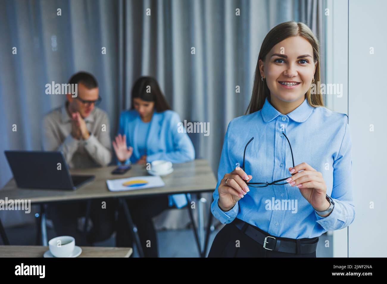 Young business lady. Manager woman in classic glasses smiling during ...