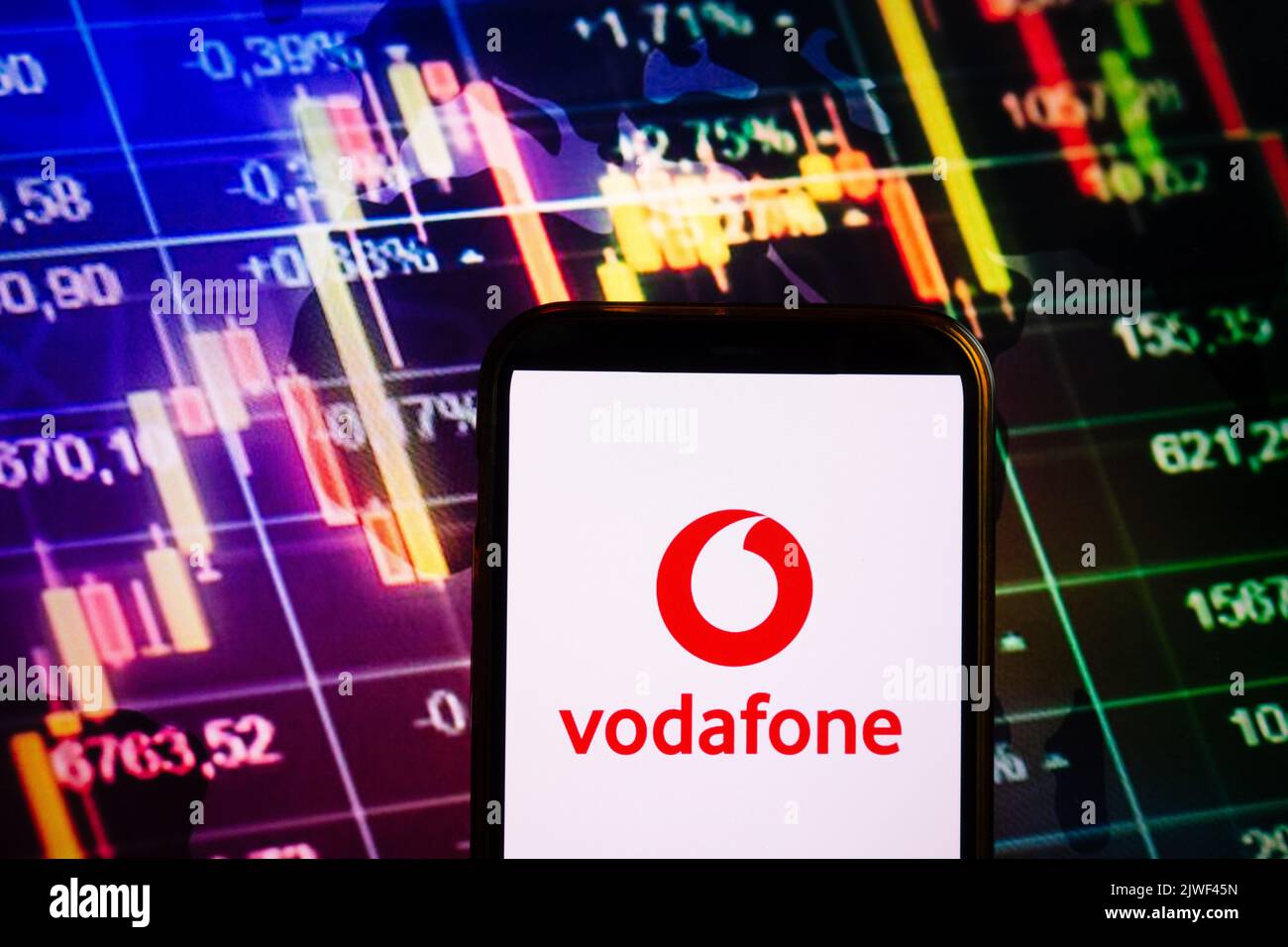 KONSKIE, POLAND - September 04, 2022: Smartphone displaying logo of Vodafone company on stock exchange diagram background Stock Photo