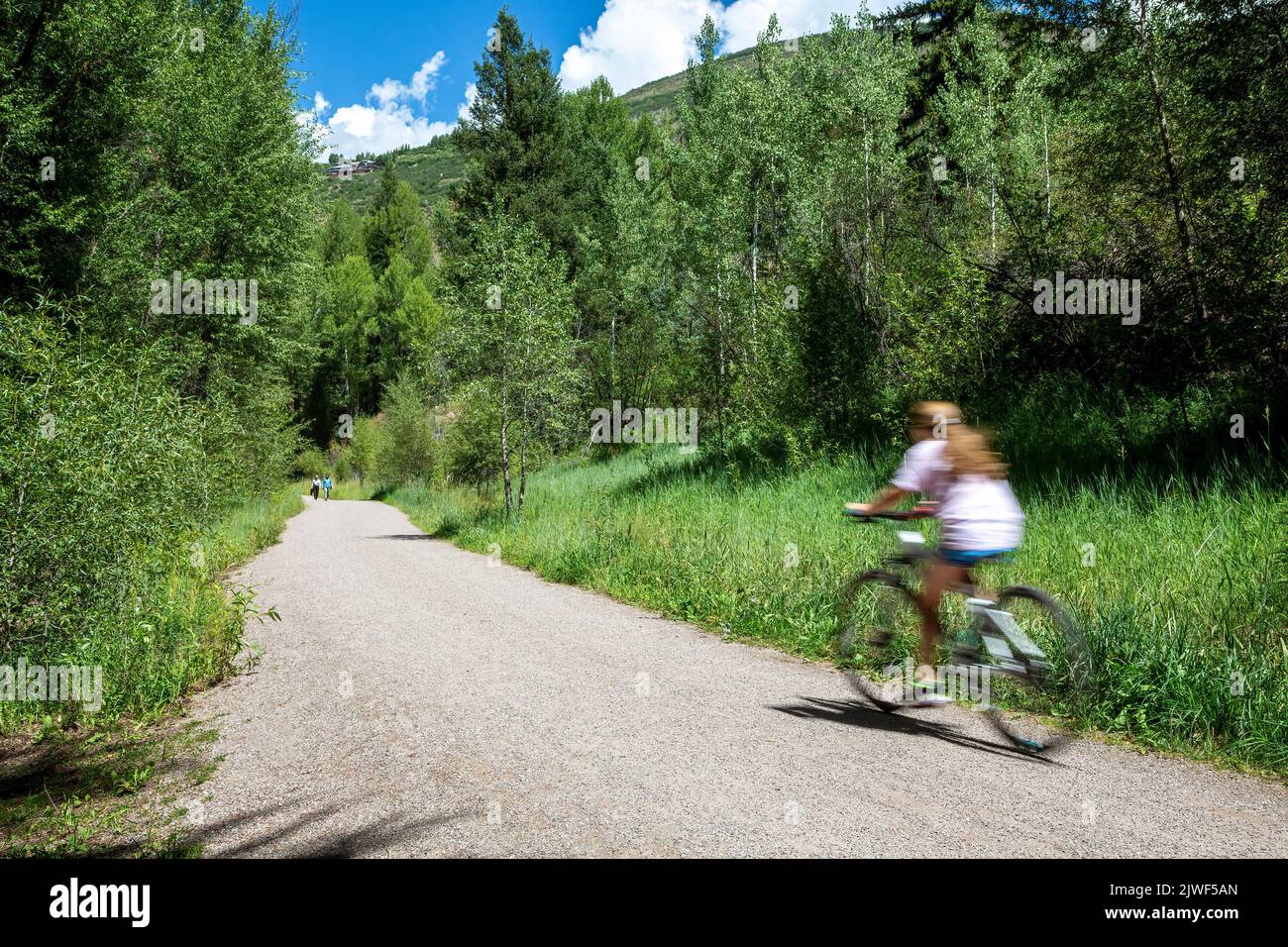 Bicycle rider and walkers on Rio Grande Trail, Aspen, Colorado USA Stock Photo